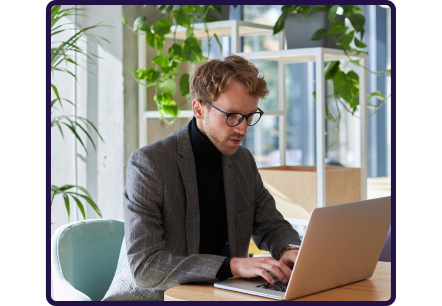 Professional man working on laptop in modern office